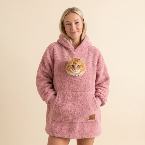 Woman wearing the pink Pawket hoodie with an orange cat in the chest pocket